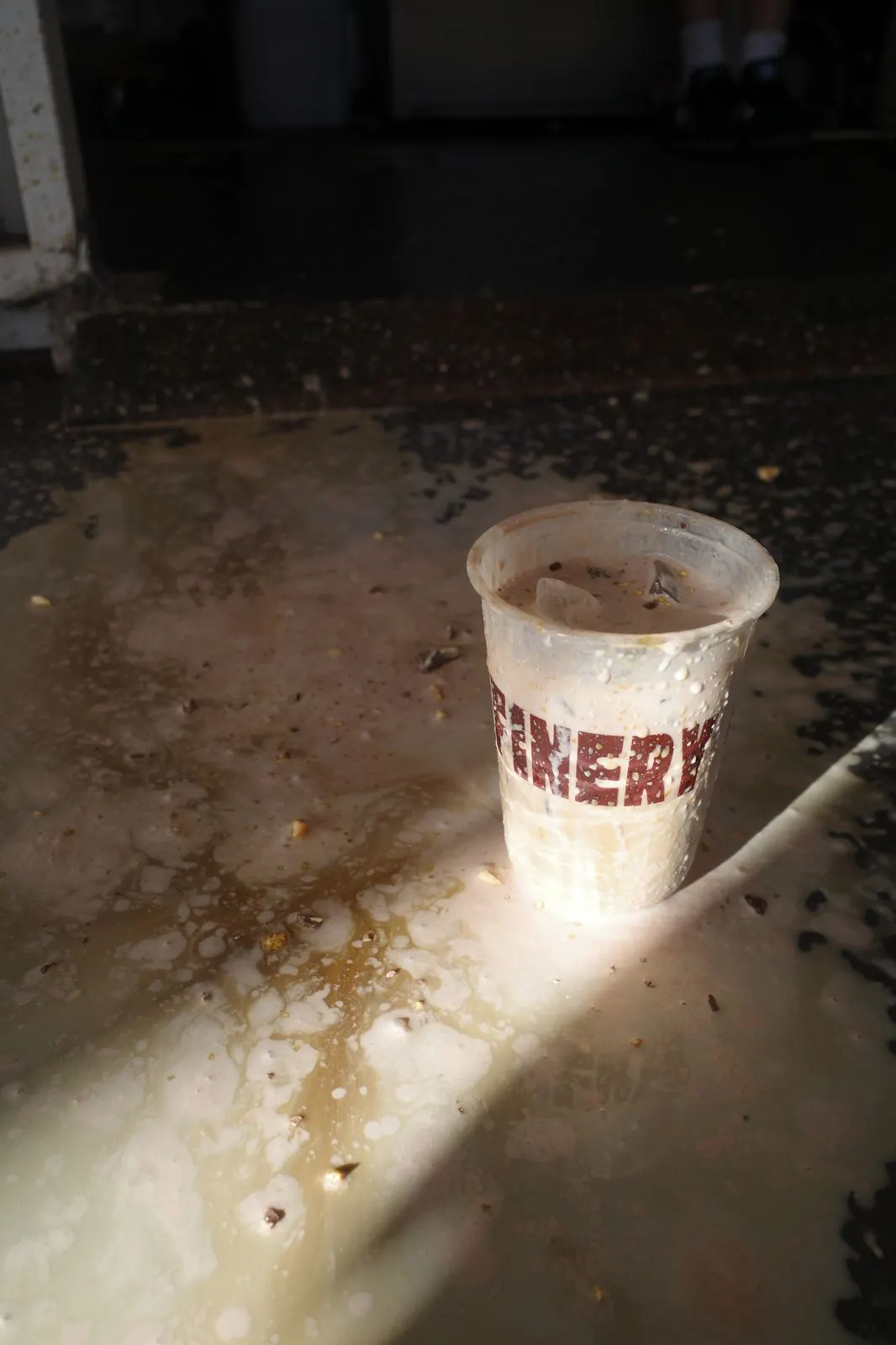 Moody splatter shot of a Refinery iced coffee