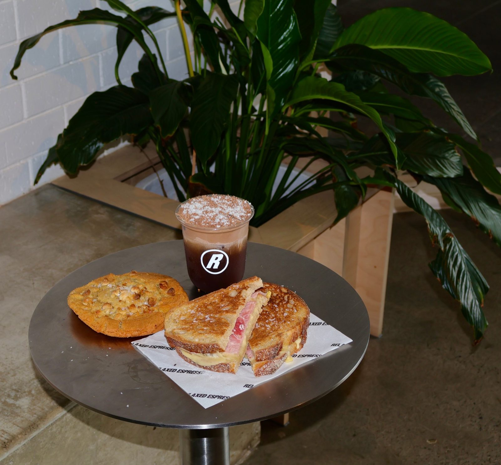 Relaxed Espresso table spread — cookie, toastie and iced chocolate