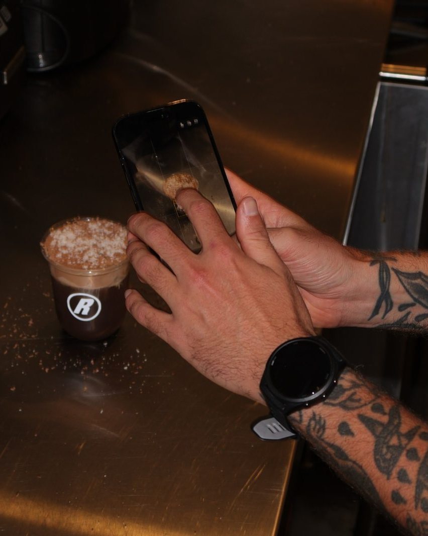 The Suede Agency shooting content behind the bar at Relaxed Espresso
